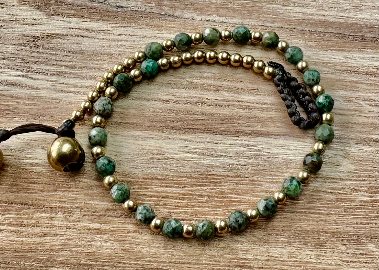 a crystal healing bracelet made of faceted african turquoise crystals on a cotton cord with brass beads